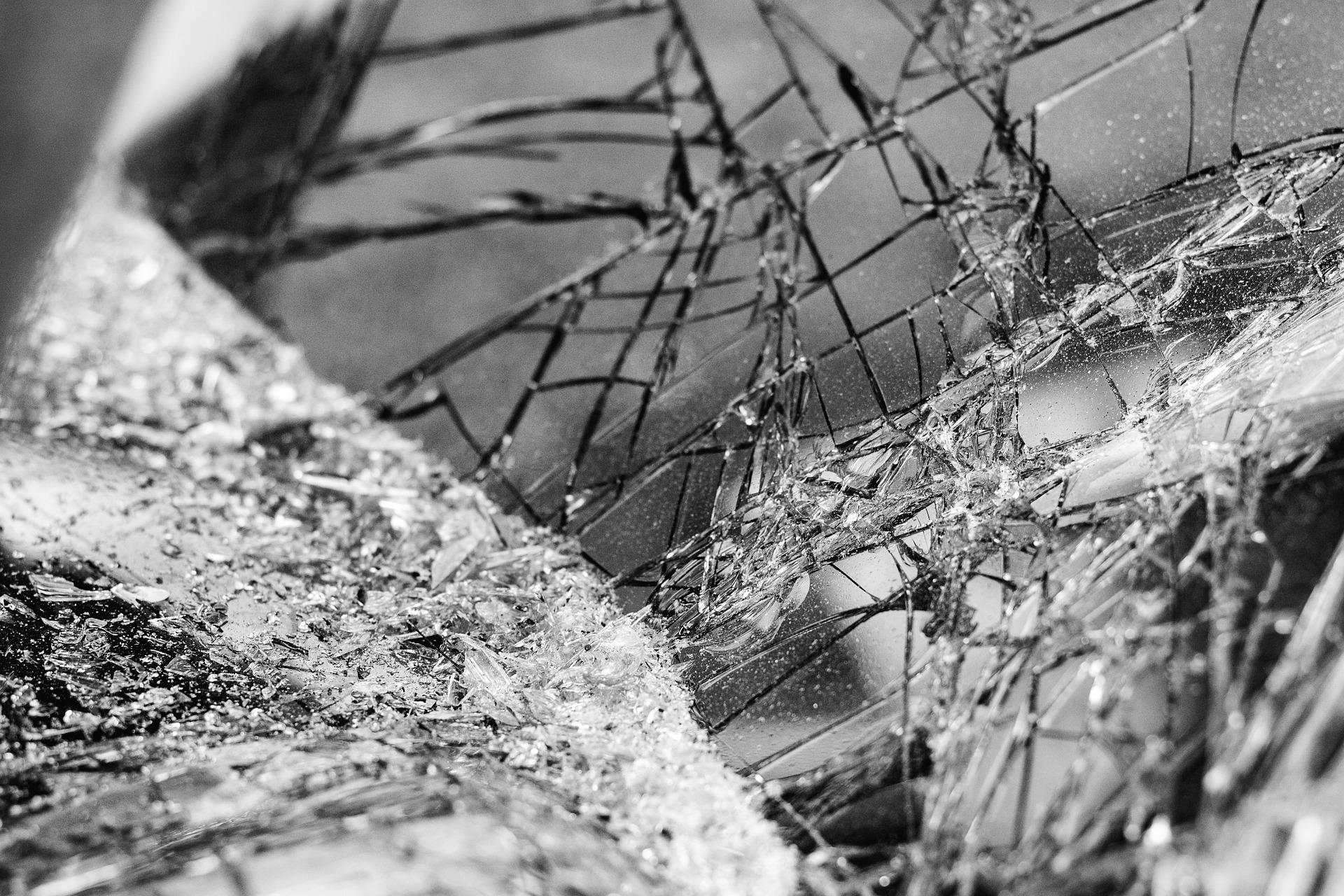 A black and white photo of a broken mirror.