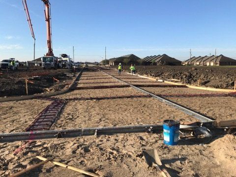 A concrete pump is being used to pour concrete on a construction site.