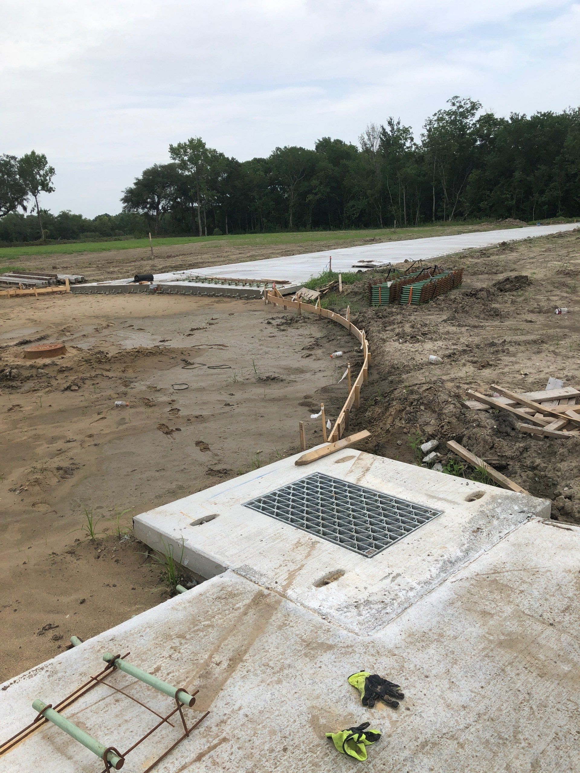 A construction site with a ladder and tools on the ground.