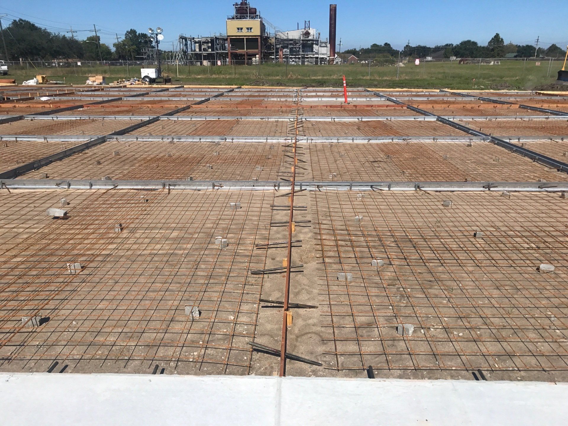 A construction site with a large building in the background