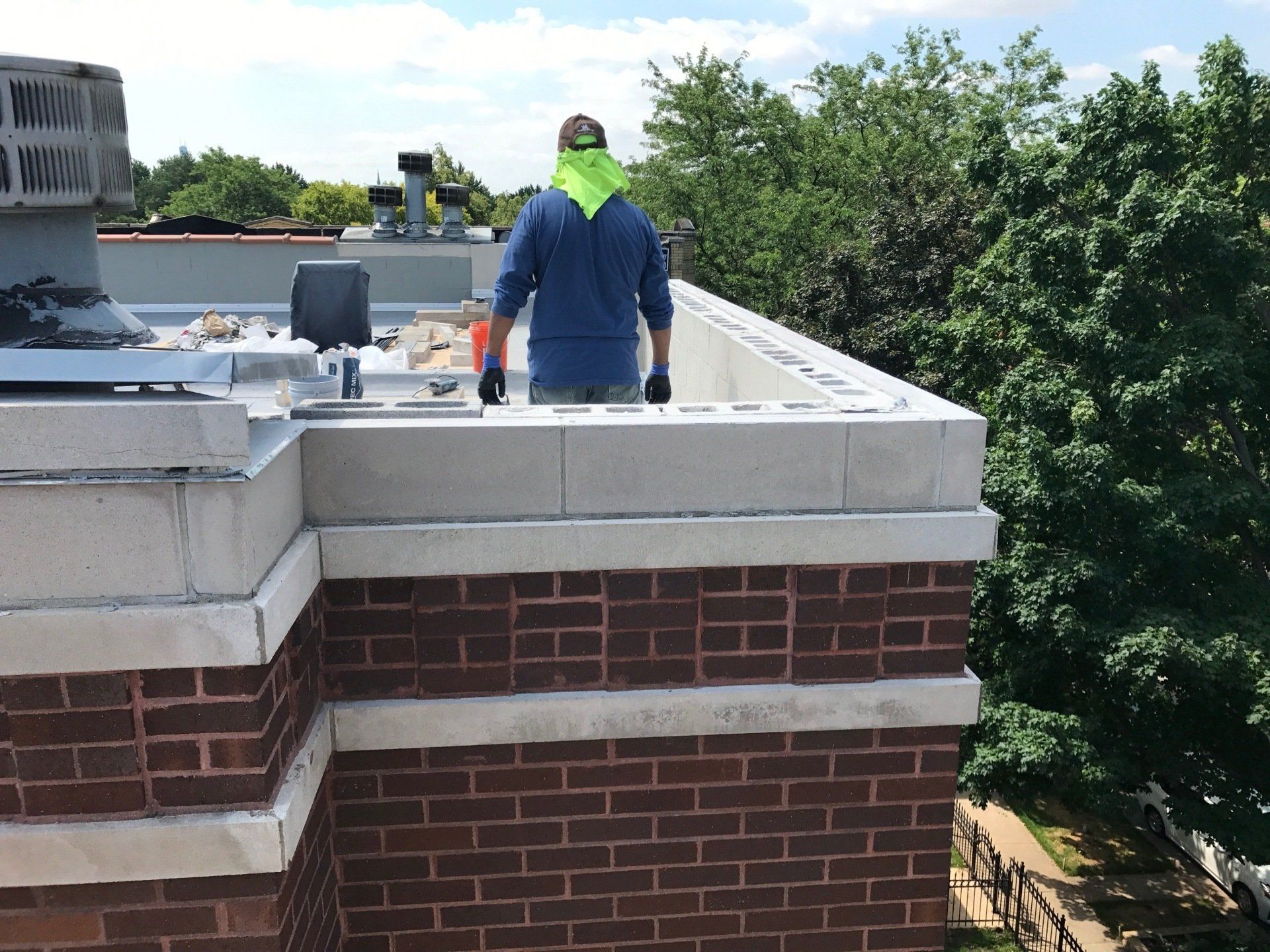 WickRight parapet vent - vented drip edge - being installed under capstones in Lincoln Park, Chicago