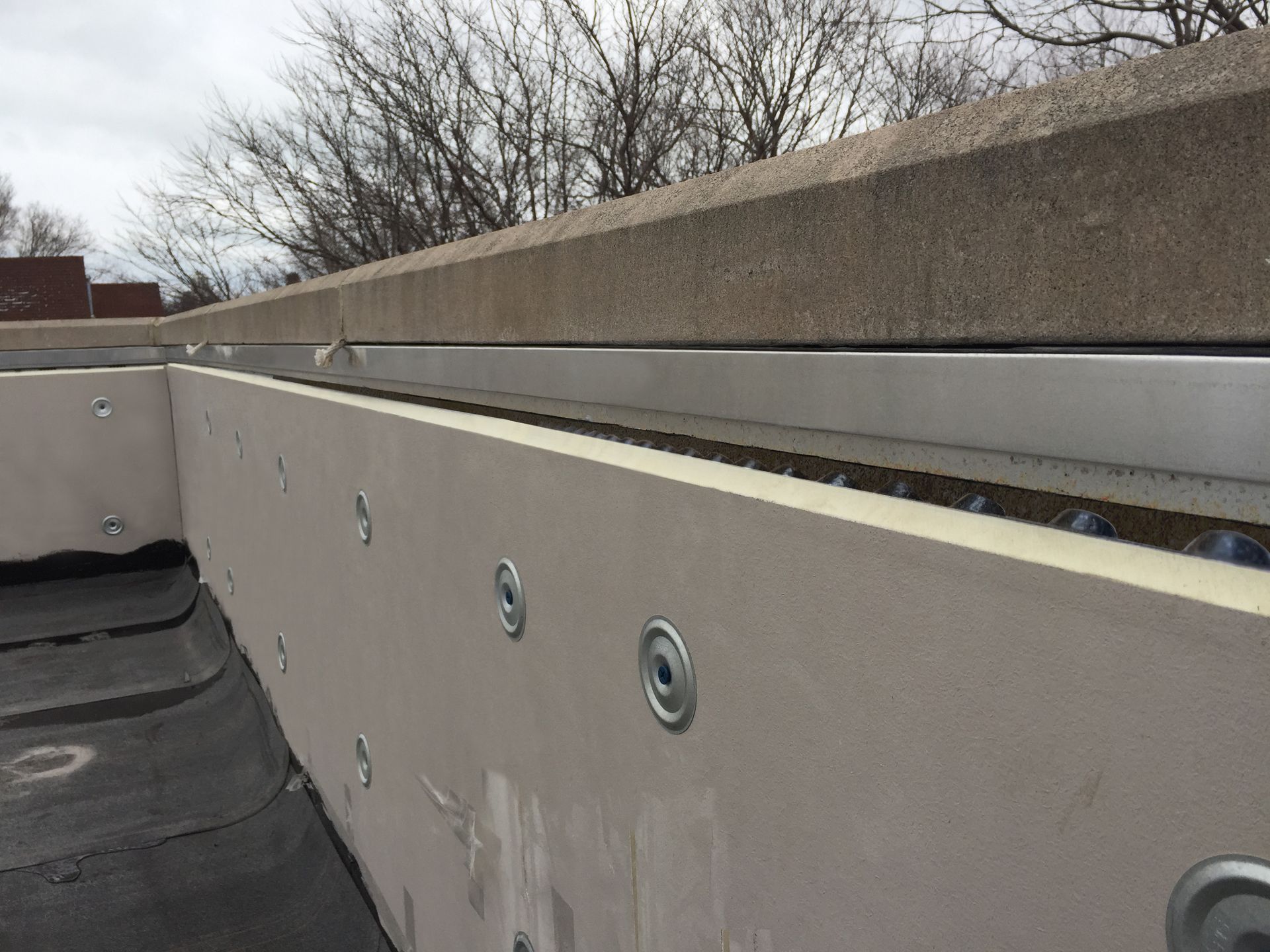 WickRight Roof Vent installed on wet parapet wall under WickRight Vented Receiver clip prior to Counter Flashing installation