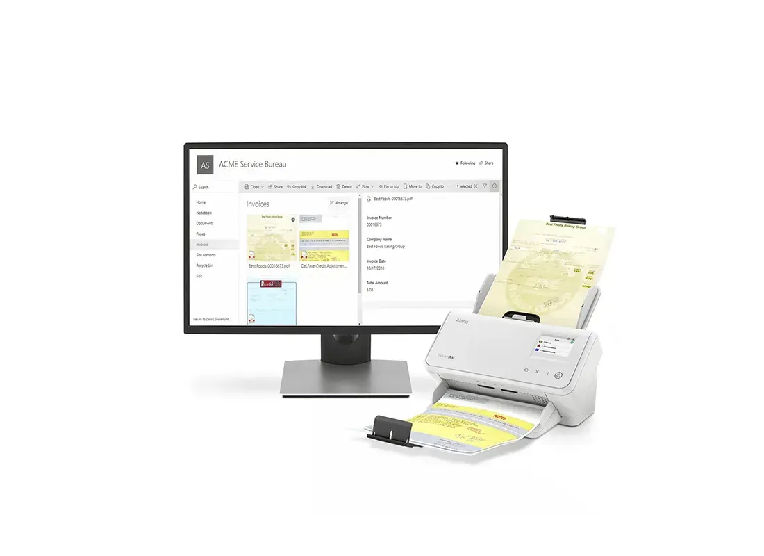 A computer monitor and scanner are sitting next to each other on a white background.