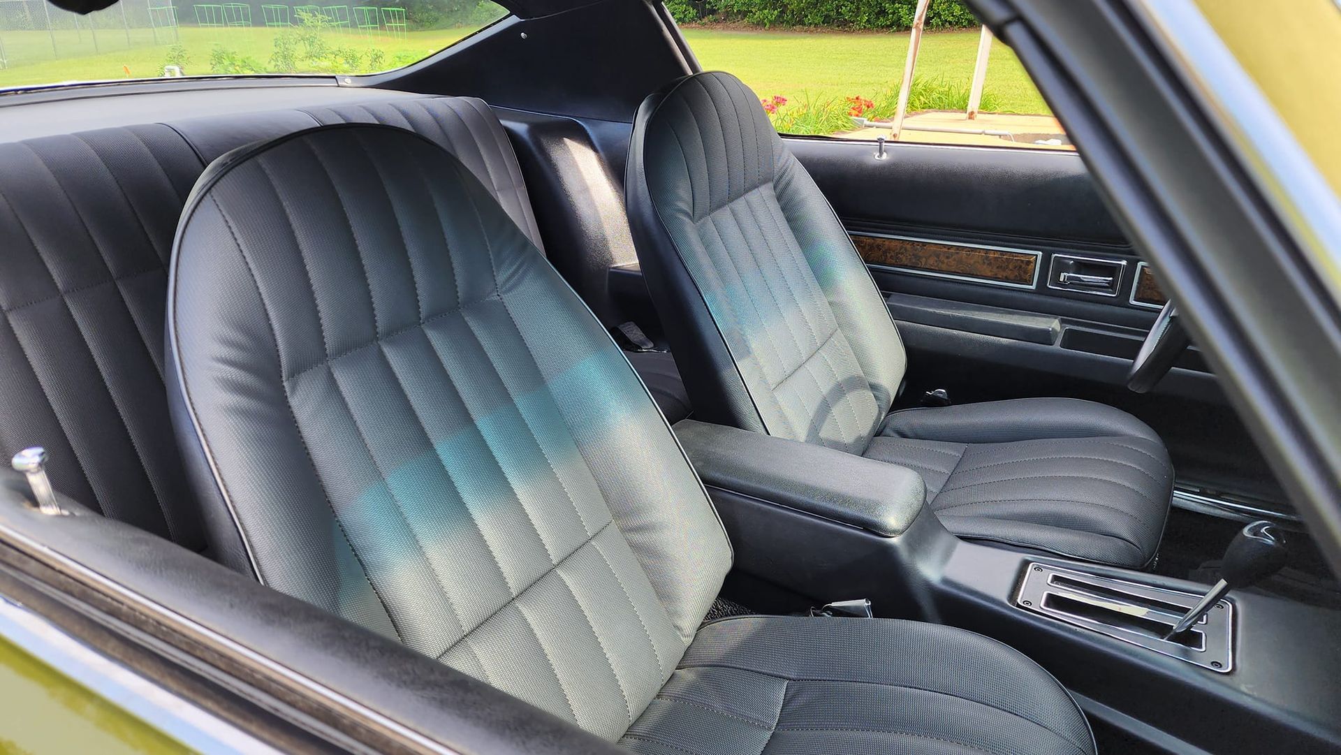 Black leather car interior with bucket seats and center console.