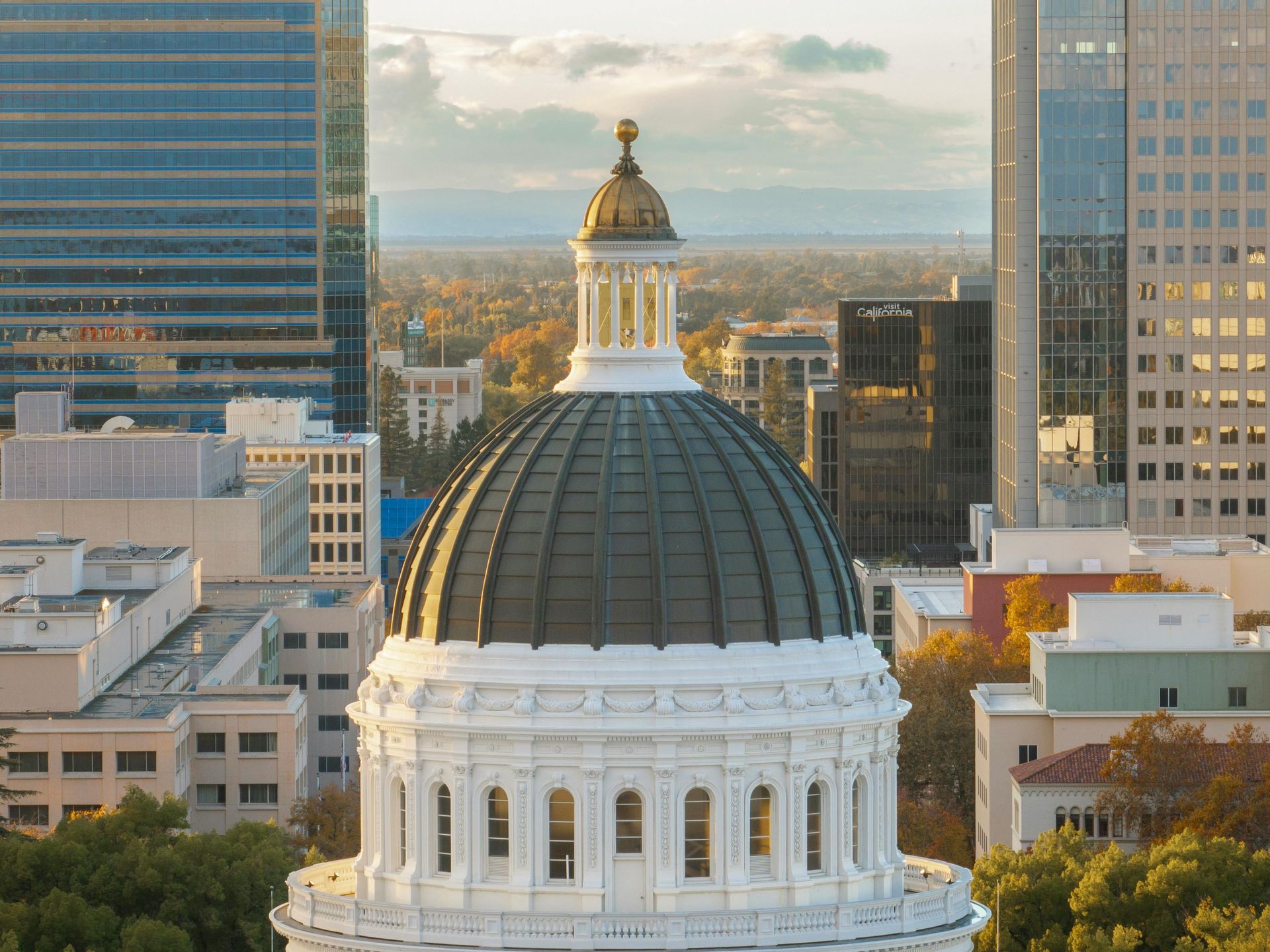 Aerial view of Sacramento skyline featuring the California State Capitol, highlighting the urgency