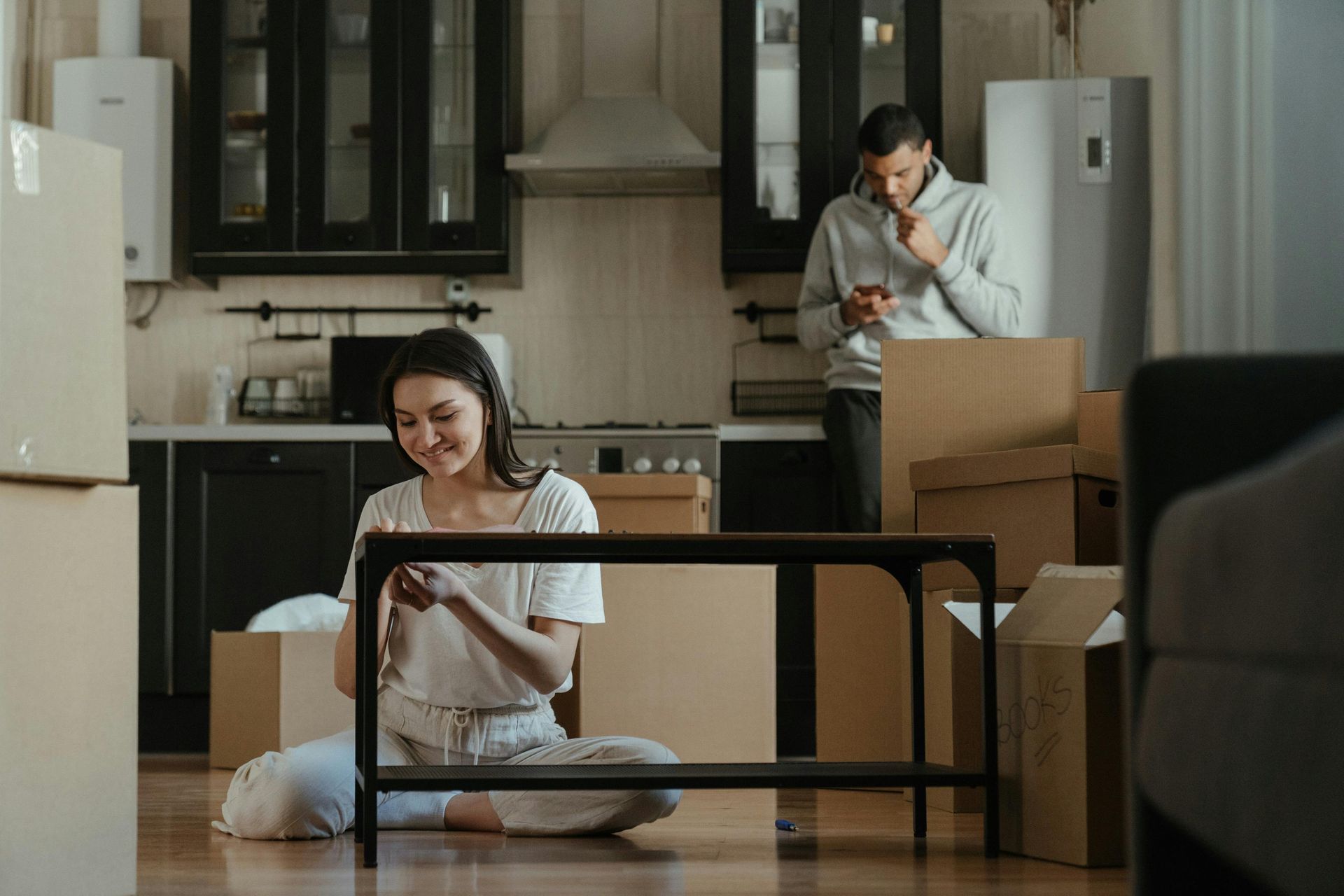 A residential property manager discussing lease terms with a homeowner in a modern office setting.