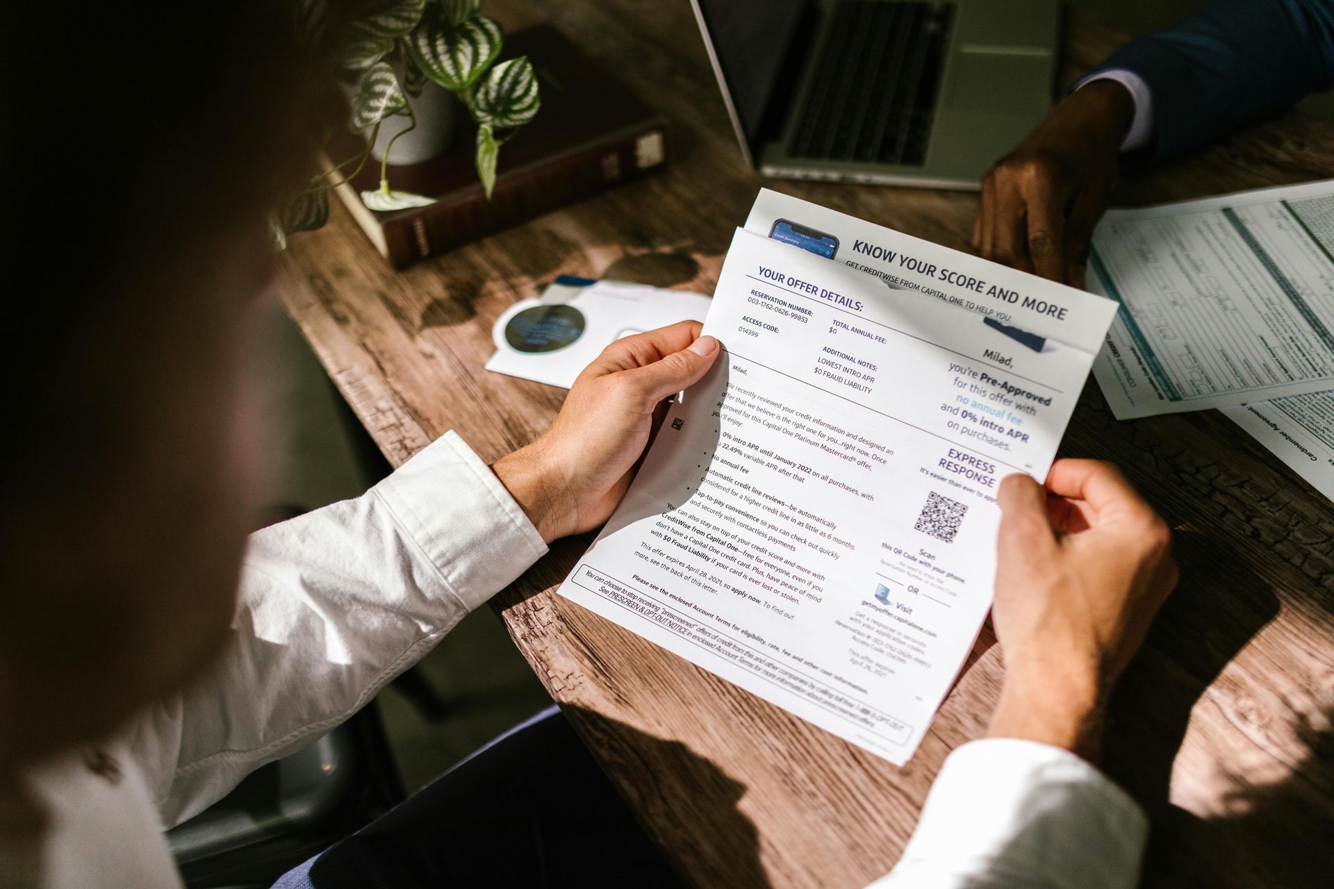 A property manager reviewing a paper copy of a credit report