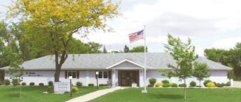 A white house with a flag in front of it.