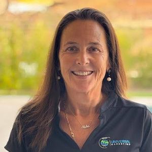 A woman in a black shirt is smiling for the camera.