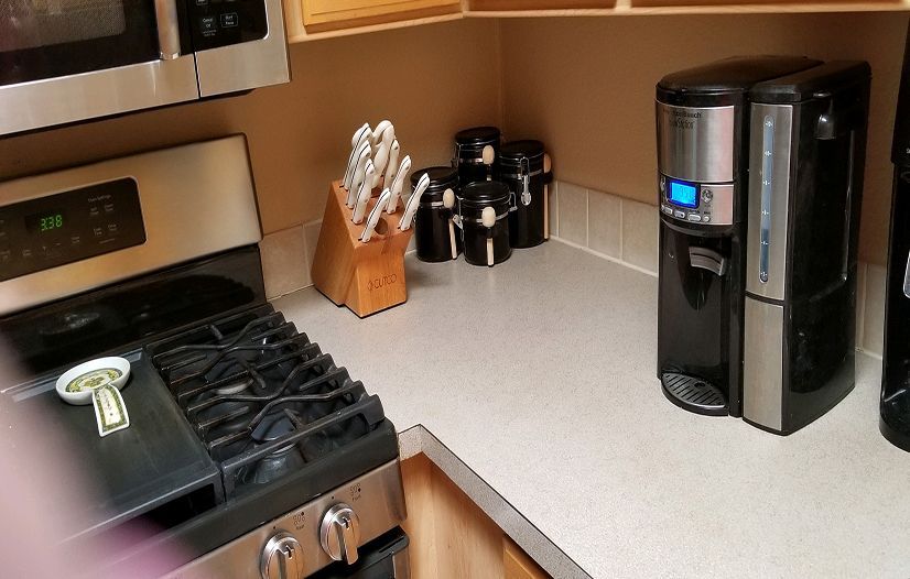 A kitchen with a stove and a coffee maker