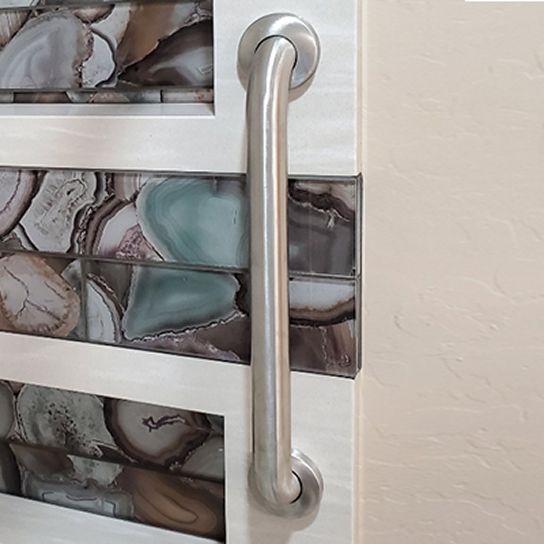 A close up of a stainless steel handle on a door.