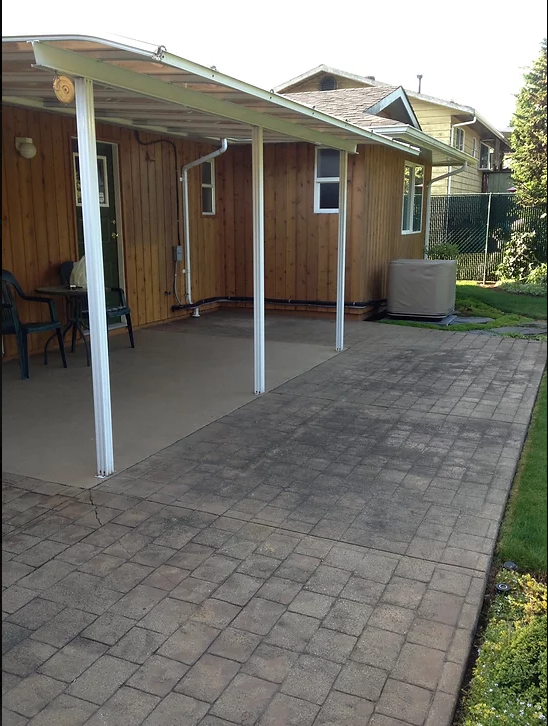A house with a covered patio in front of it