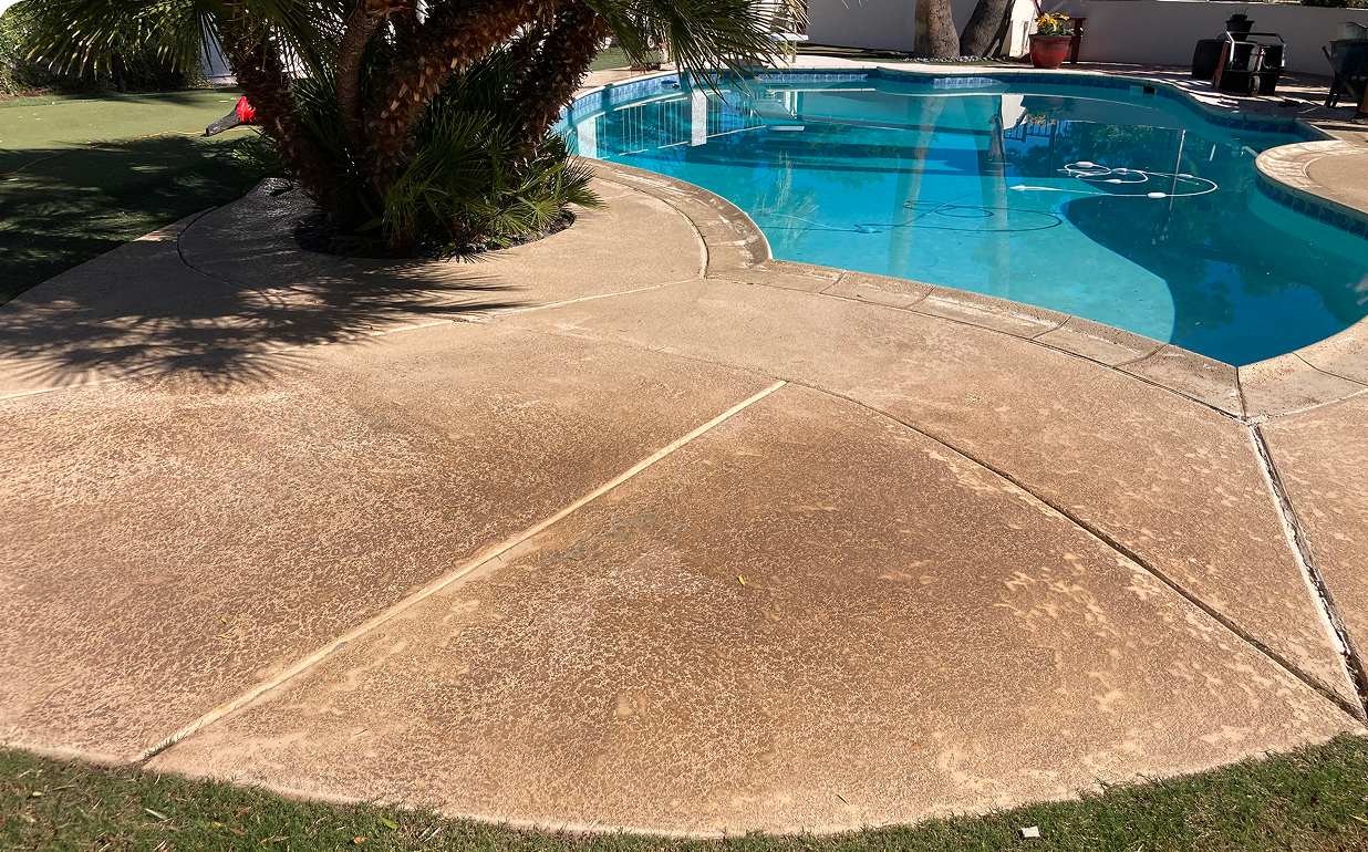 A brick patio with a swimming pool in the background.