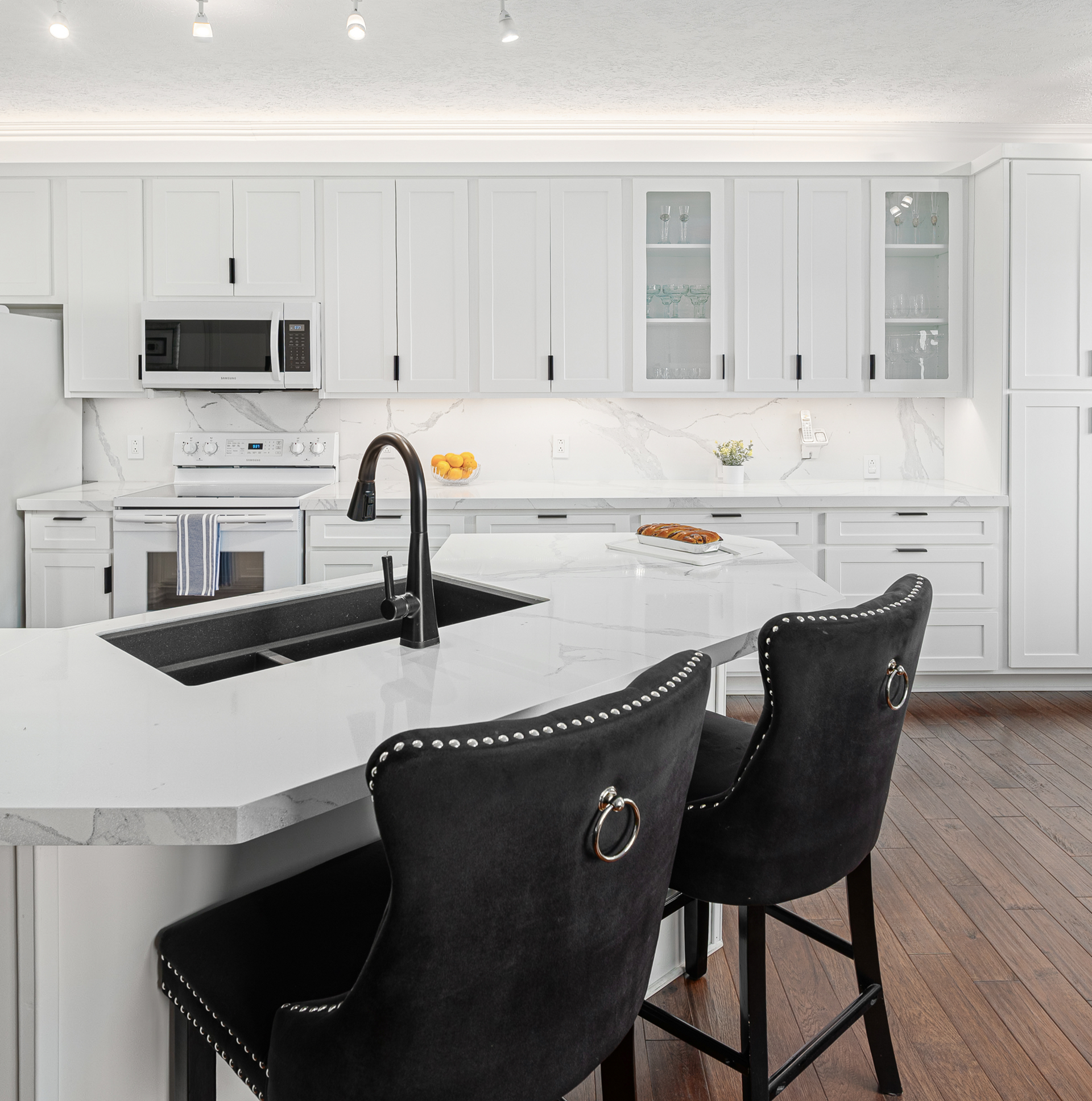 A kitchen with stainless steel appliances and white cabinets