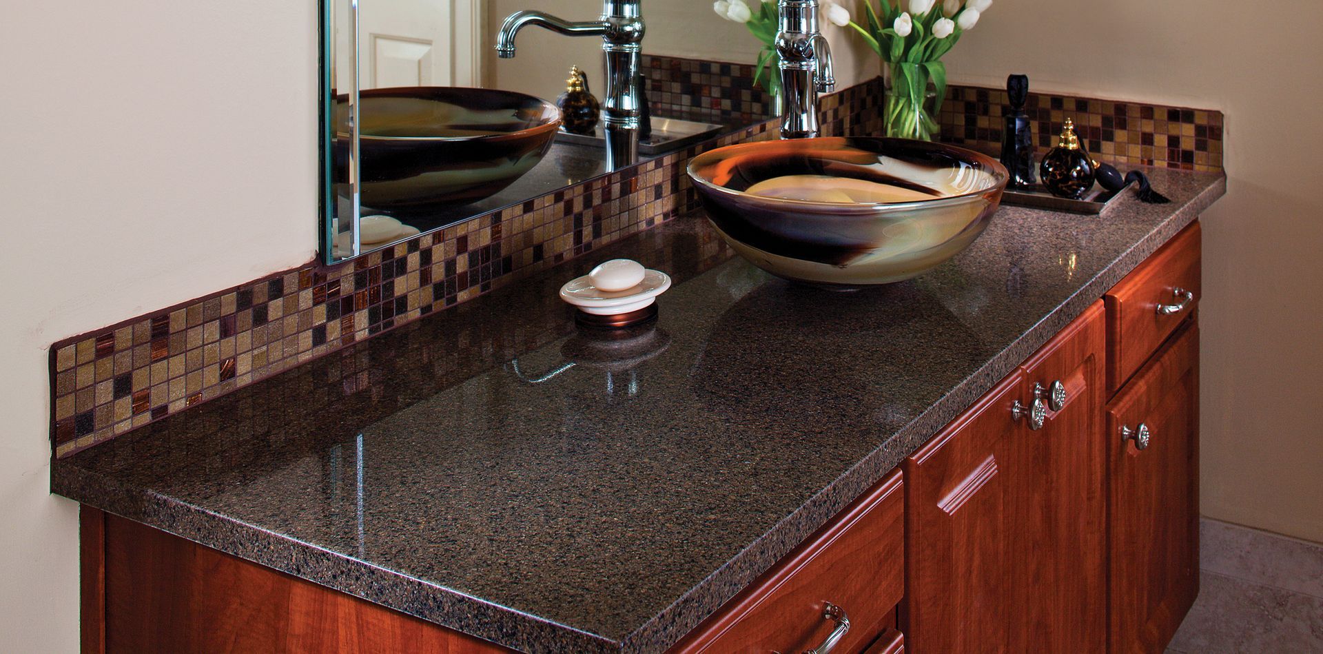 A bathroom counter with a sink and a mirror