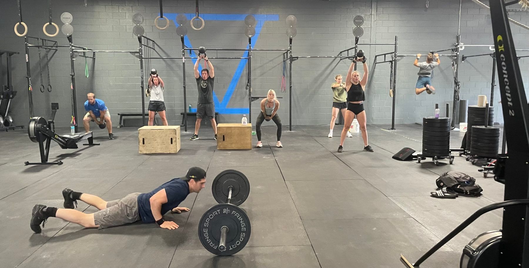 A group of people are doing exercises in a gym.