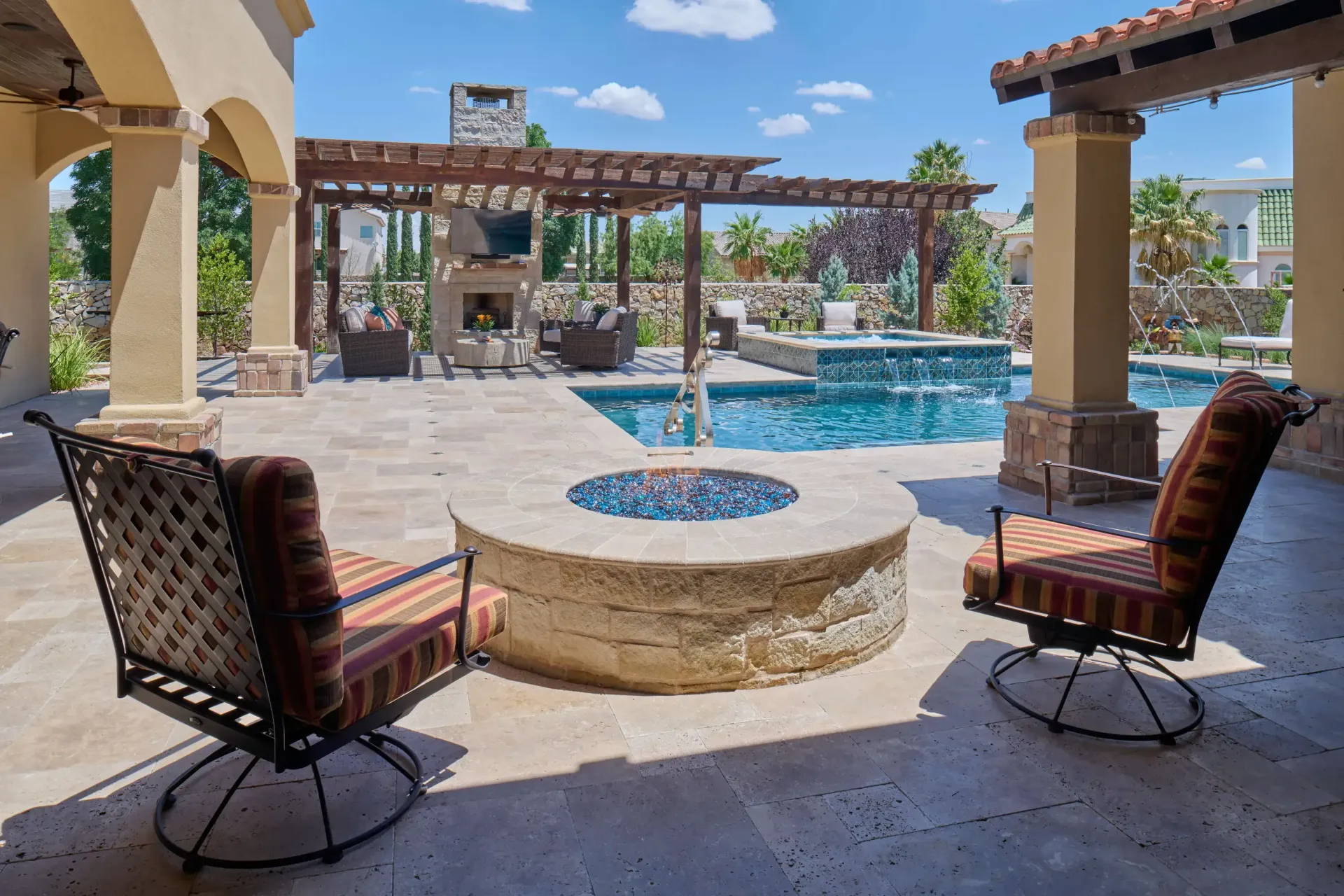 Patio with a fire pit and pool, featuring seating and a pergola.