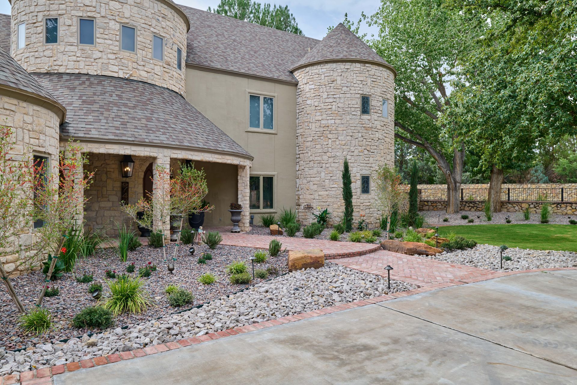 Stone house exterior with brick pathway and landscaping.