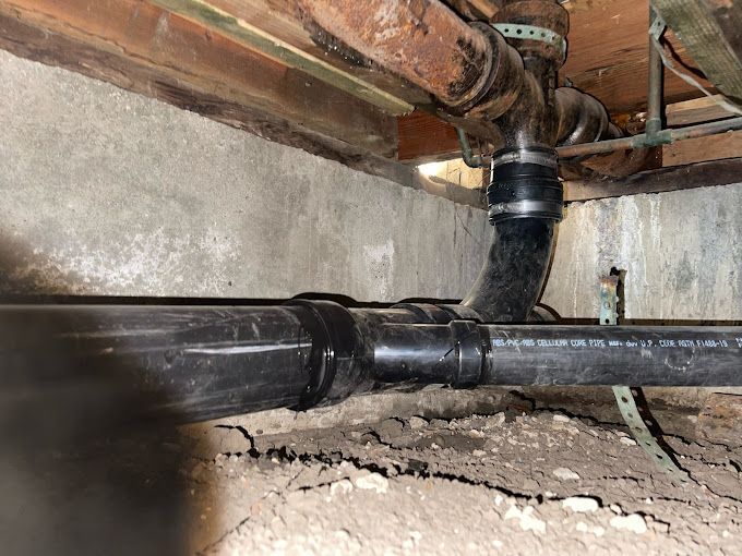 A bunch of pipes are connected to each other in a basement.