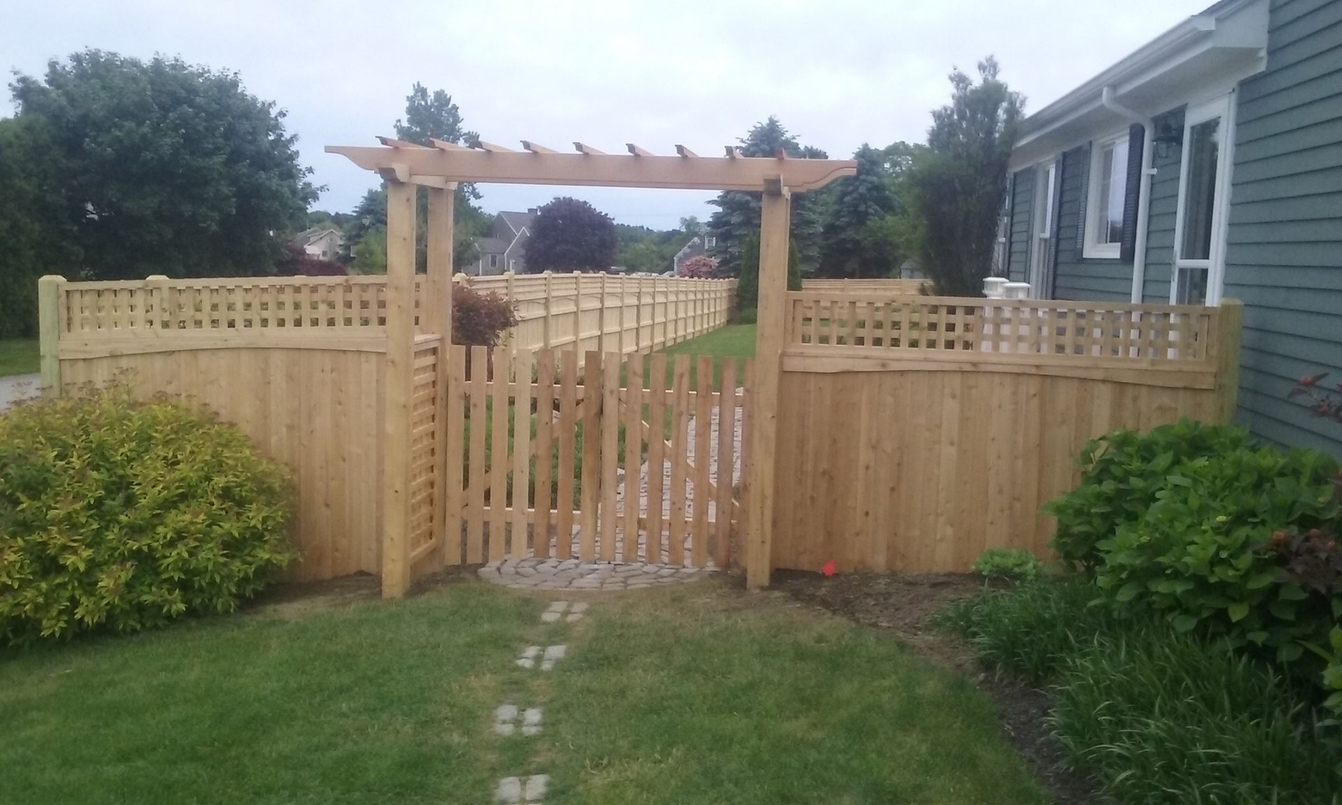 An aluminum gate door on a brick fence in Smithfield, RI by A. Belmonte & Son