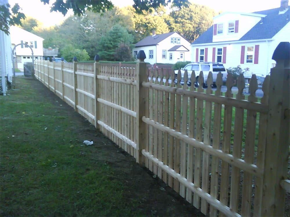 Wooden picket fence in a suburban neighborhood.