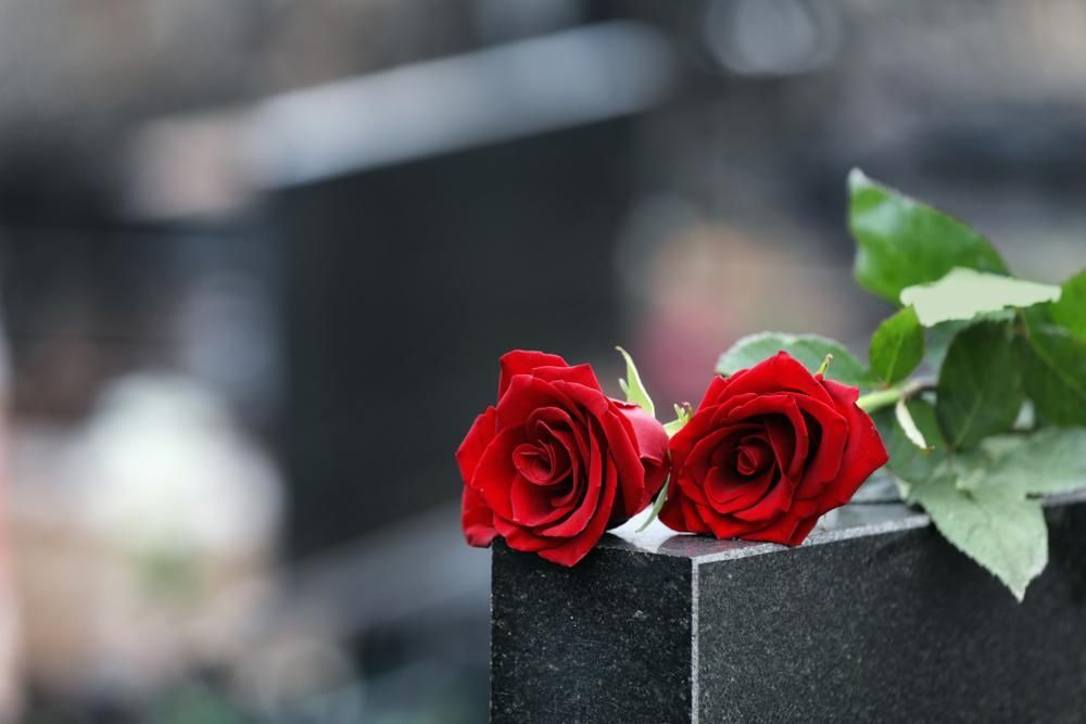 Two Red Roses Are Sitting on A Gravestone — Nick Locke Monuments in Urunga, NSW