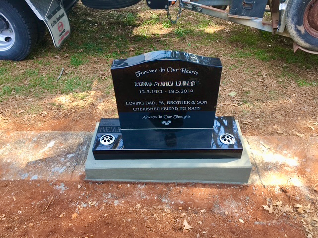 A Grave with Flowers on It in A Cemetery — Nick Locke Monuments in Bellingen, NSW