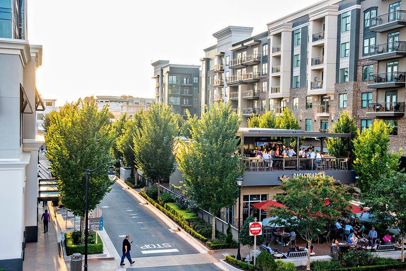 Lawyer reviewing documents at a desk; scales of justice and laptop present.