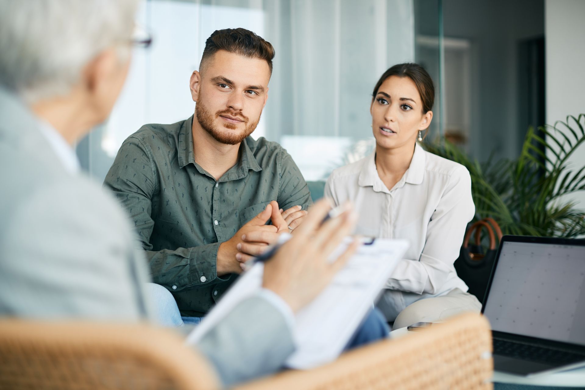 Couple consulting with a counselor in an office setting.