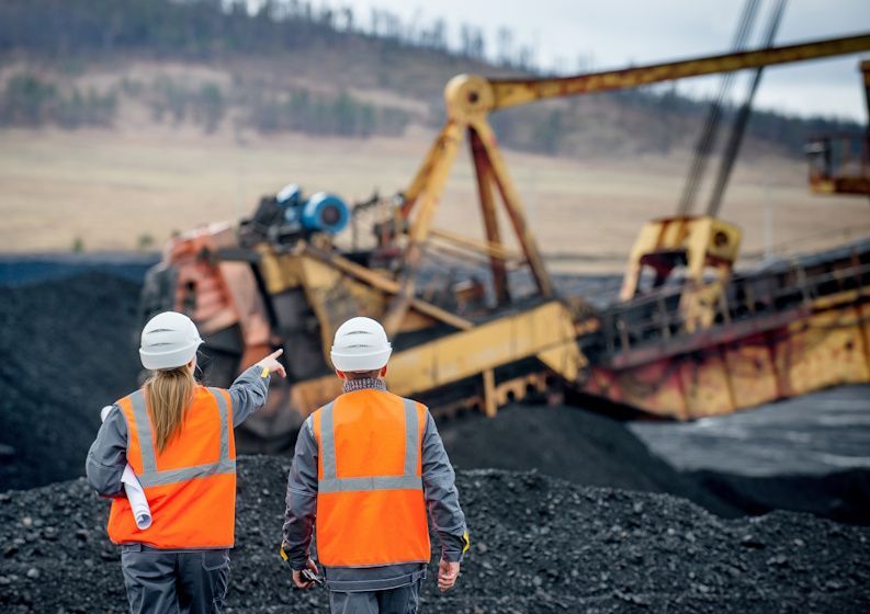 mining workers overlooking project