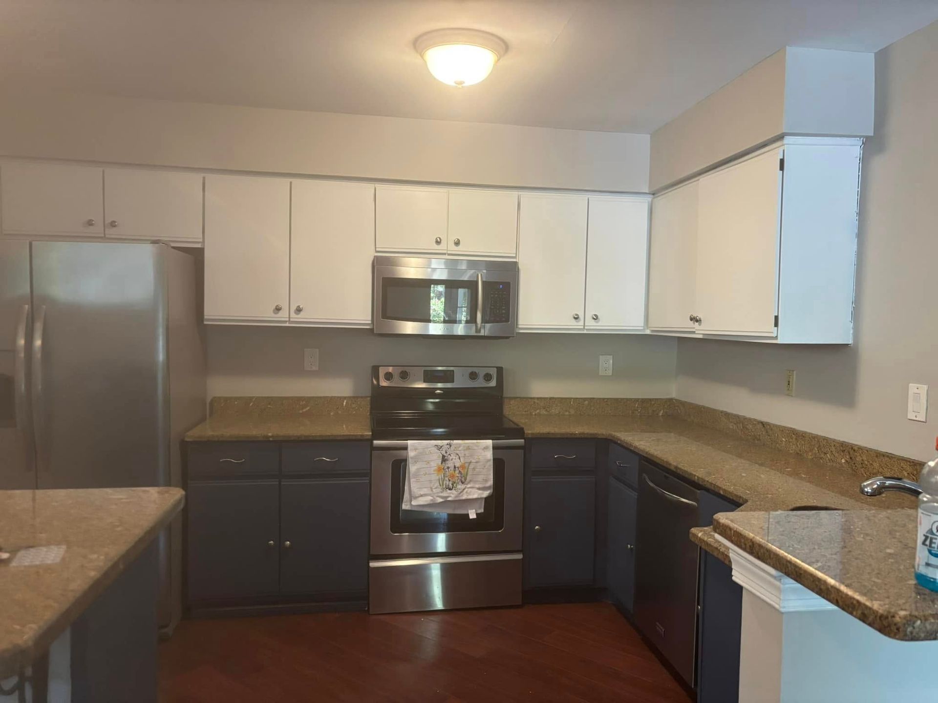 A kitchen with stainless steel appliances and white cabinets