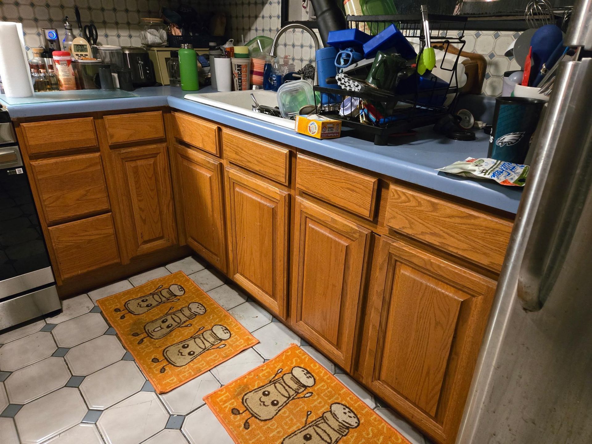 A kitchen with wooden cabinets and a blue counter top