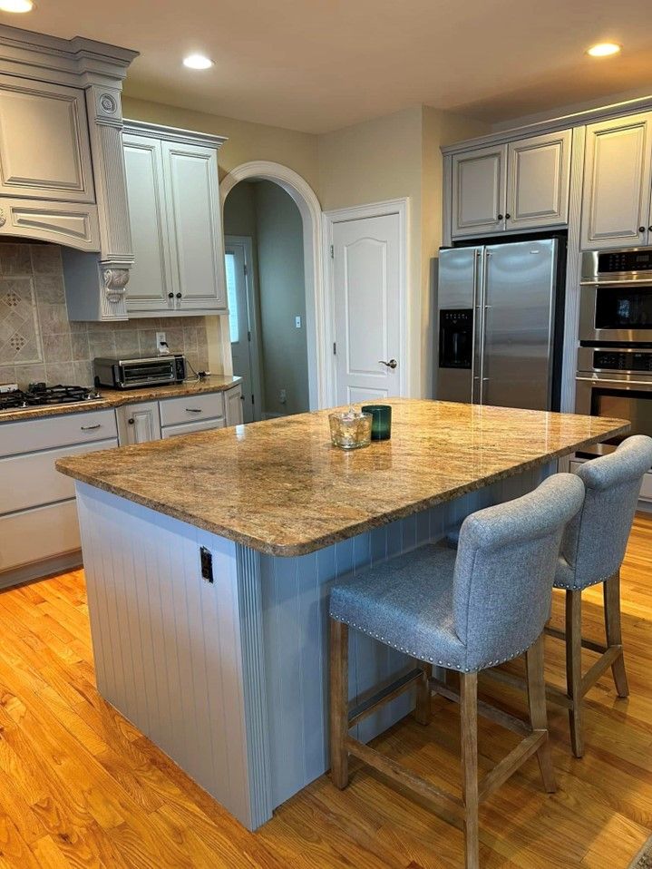 There is a large island in the middle of the kitchen.