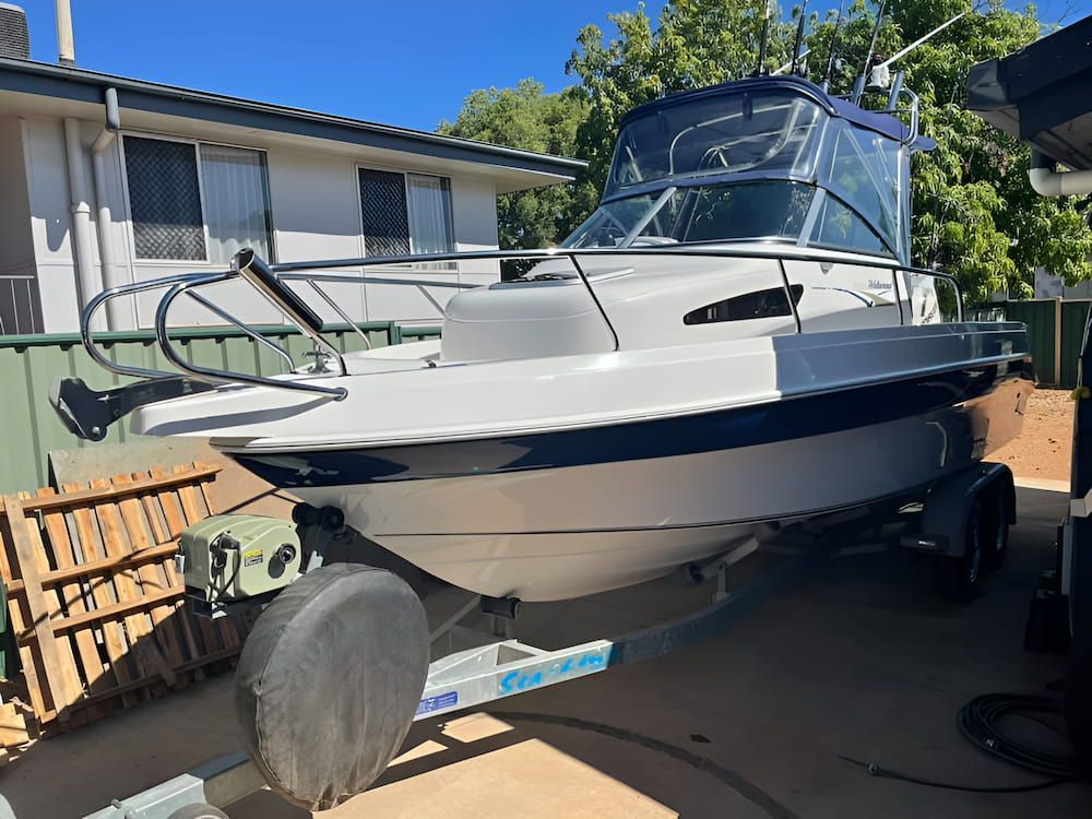 A Boat is Parked on a Trailer in Front of a House — TB Detailing in Miles End, QLD