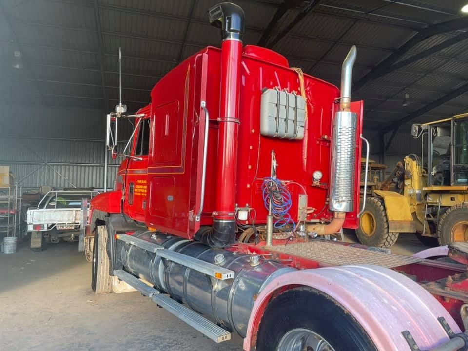 A Red Semi Truck is Parked in a Warehouse — TB Detailing in Miles End, QLD