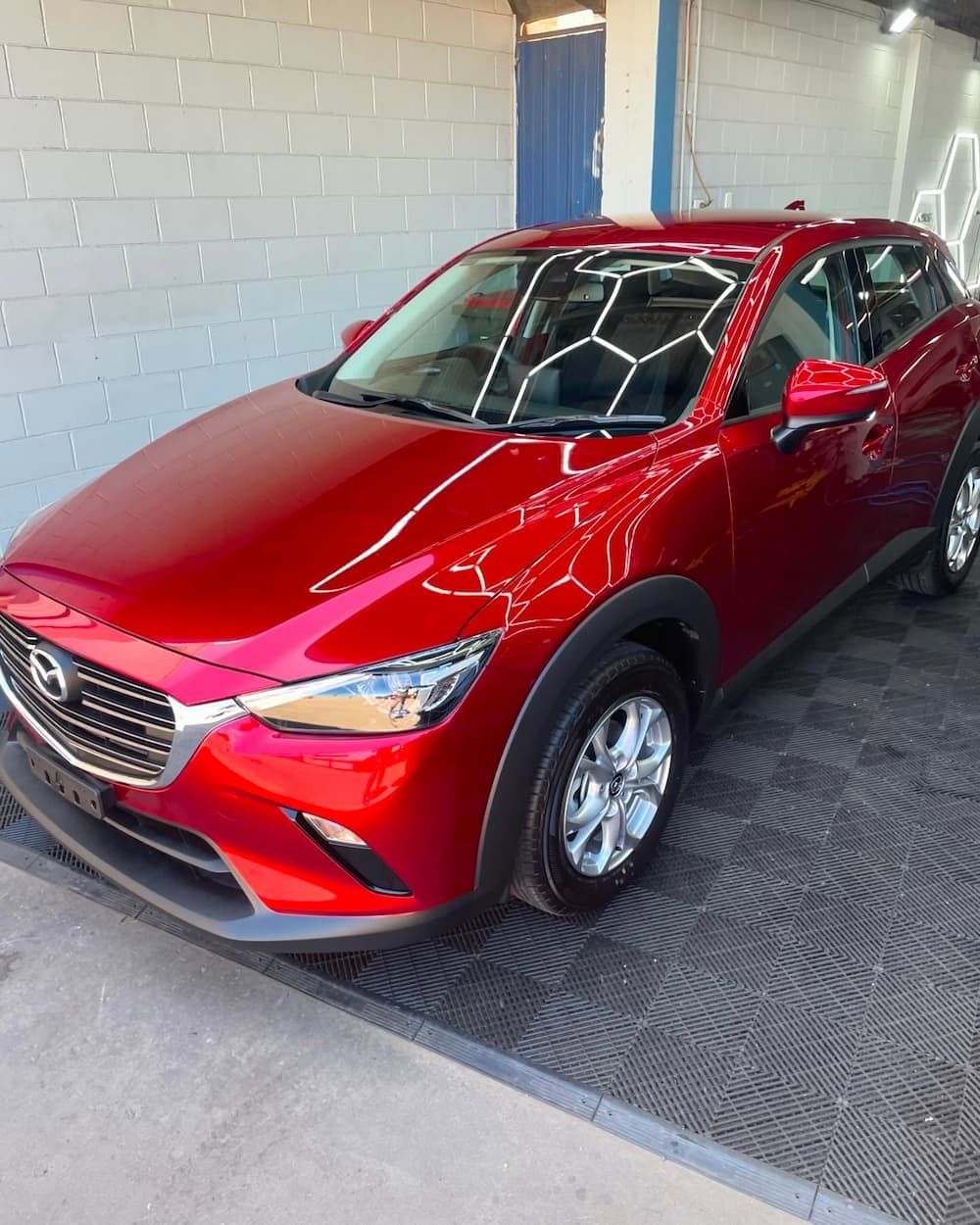 A Red Car is Parked in Front of a Building — TB Detailing in Miles End, QLD