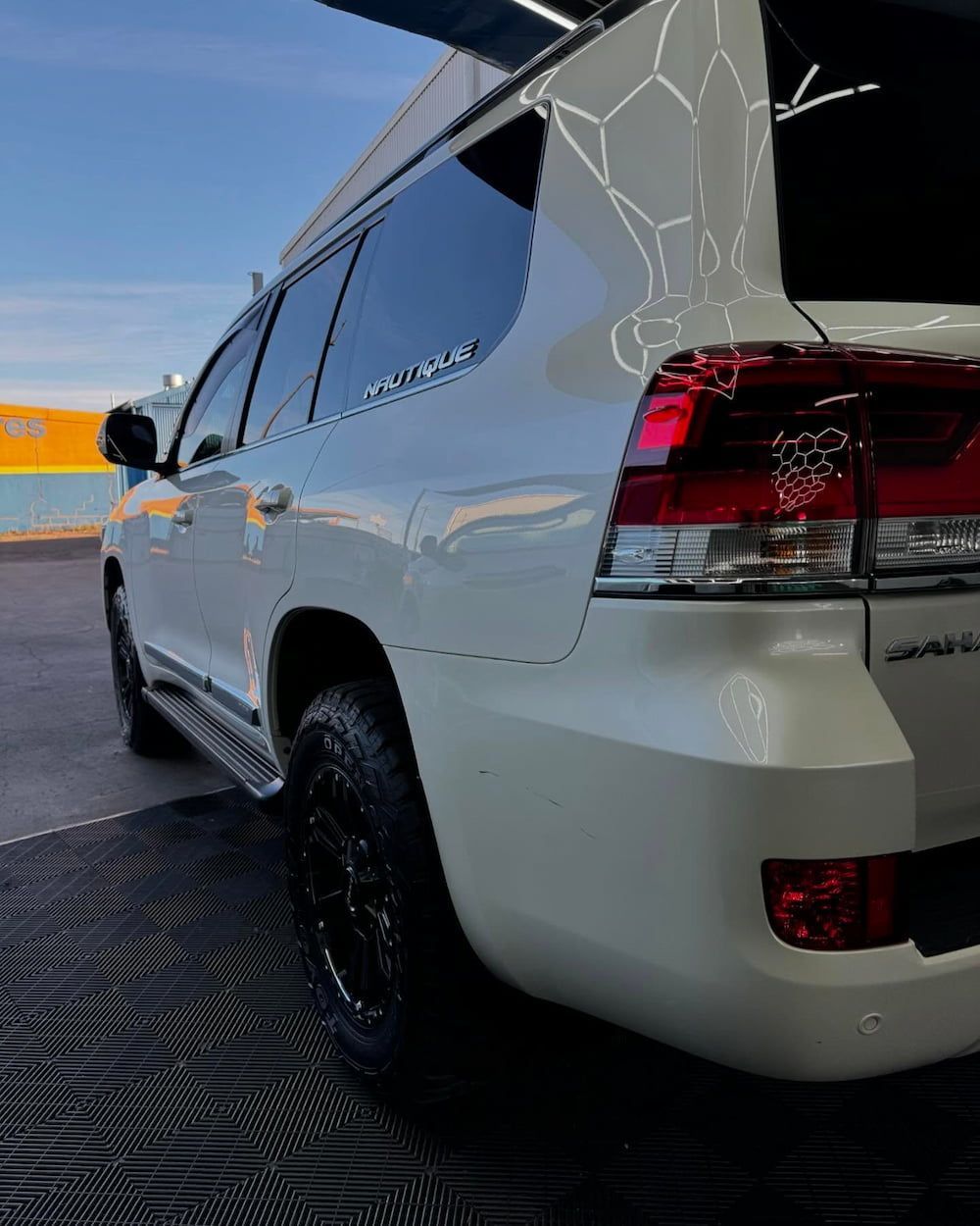 A White Suv is Parked in a Parking Lot With Its Trunk Open — TB Detailing in Miles End, QLD