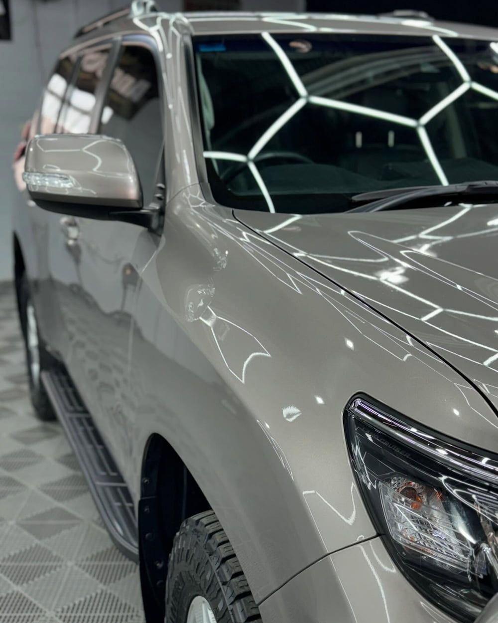 A Car is Parked on a Tiled Floor in a Garage — TB Detailing in Miles End, QLD