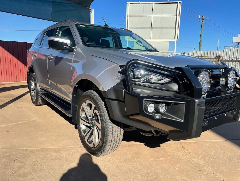 A Gray Suv With a Black Bumper is Parked in a Parking Lot — TB Detailing in Miles End, QLD