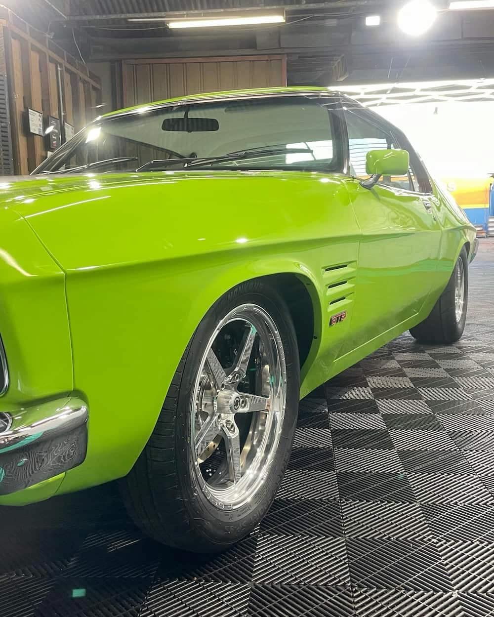 A Green Car is Parked in a Garage — TB Detailing in Miles End, QLD