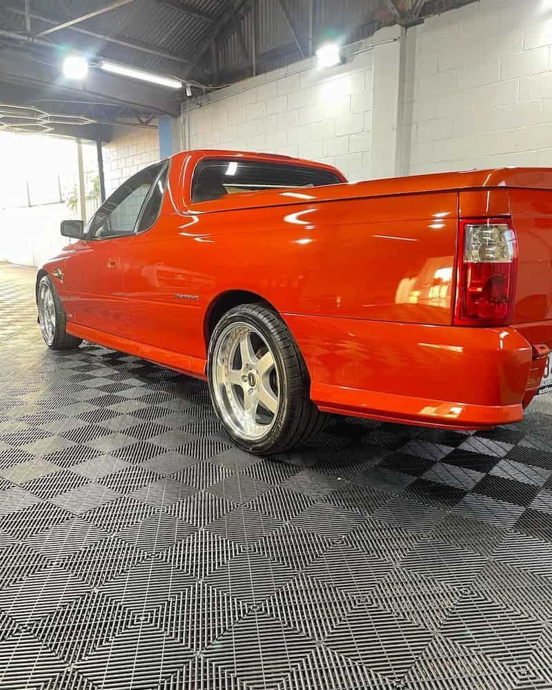 A Red Pickup Truck is Parked in a Garage — TB Detailing in Miles End, QLD