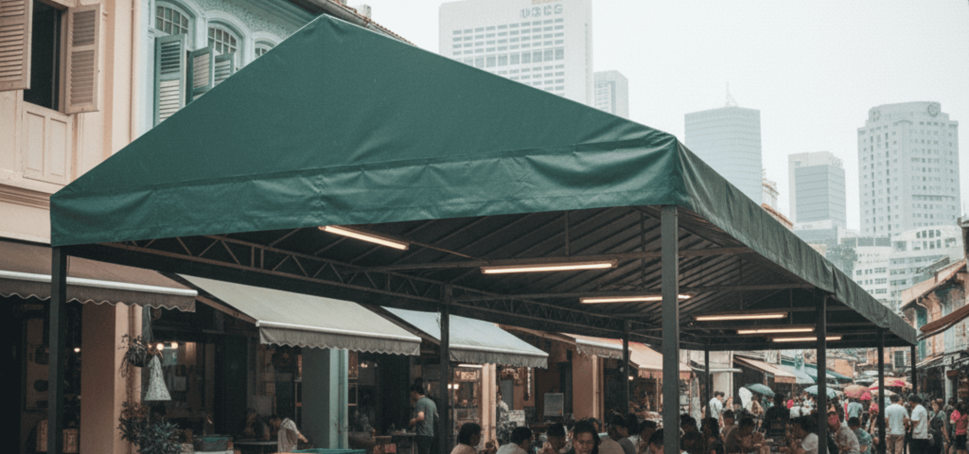 Green freestanding awning sheltering diners in Singapore