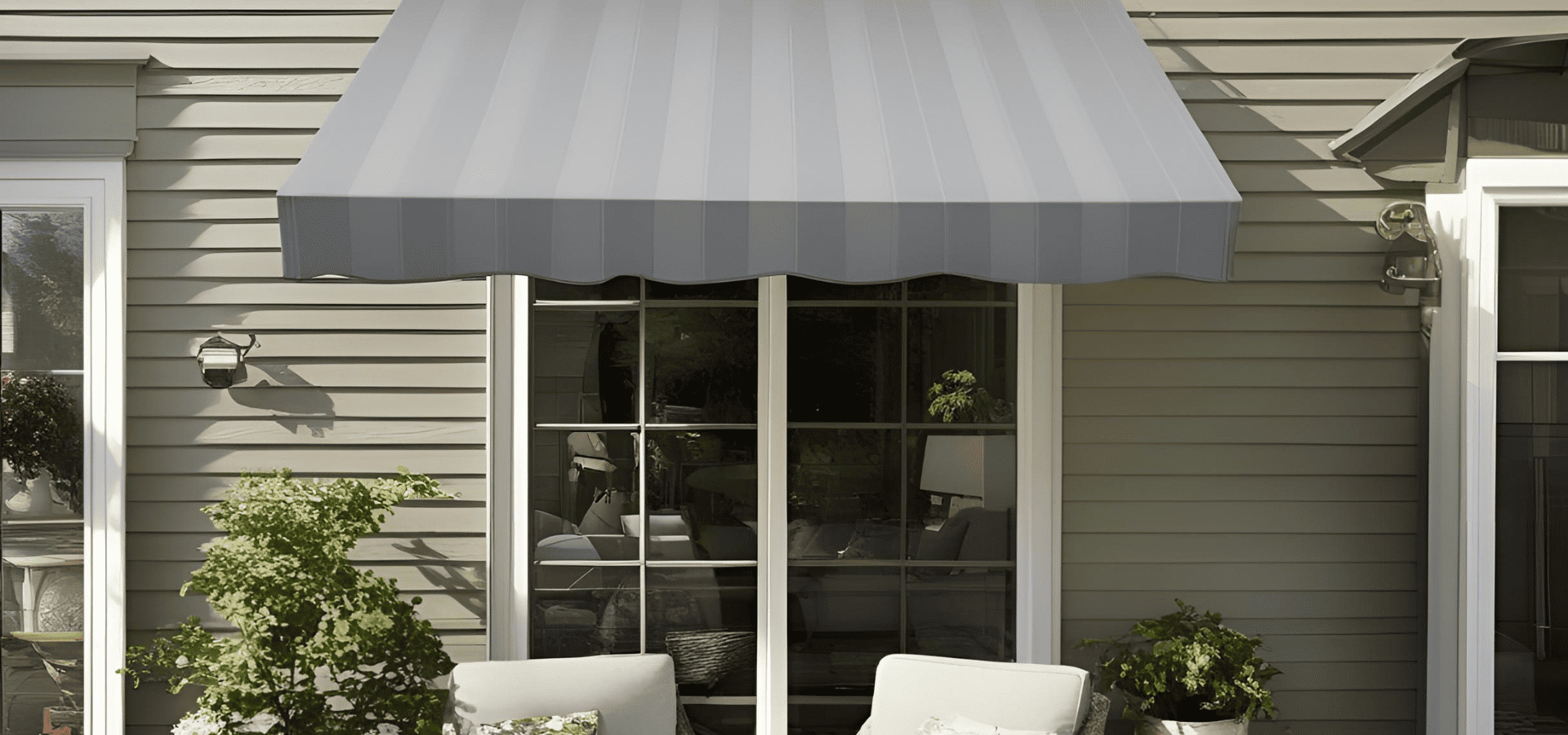 Grey retractable awning sheltering a patio in a landed property