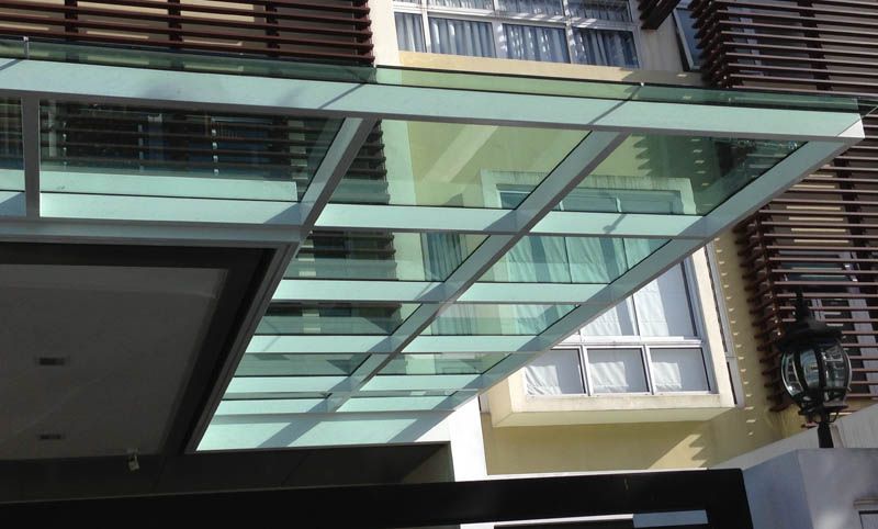 A laminated tempered glass awning installed for a homeowner by Uni Shades