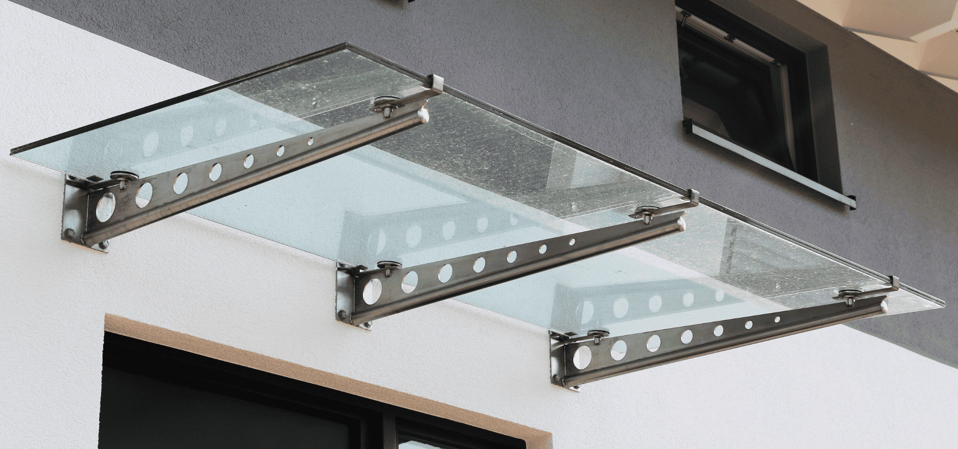 A glass awning above the front door of a bungalow in Singapore
