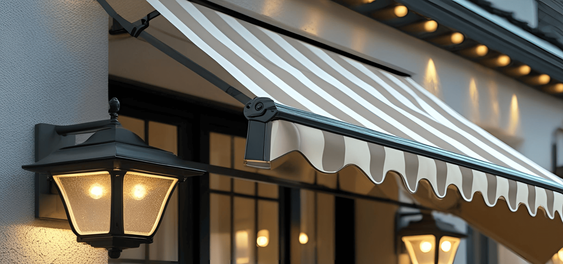 Wall-hanging lantern lights beside awning to light up outdoor patio