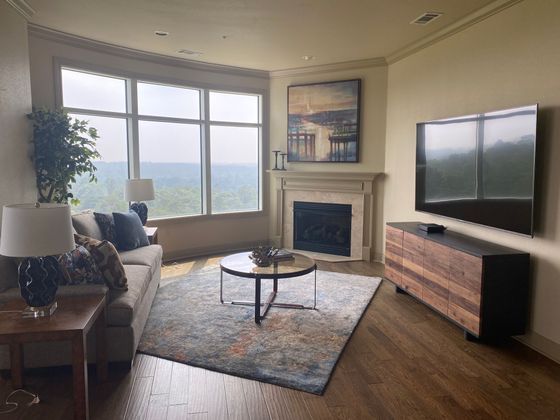 A living room with a fireplace and a flat screen tv