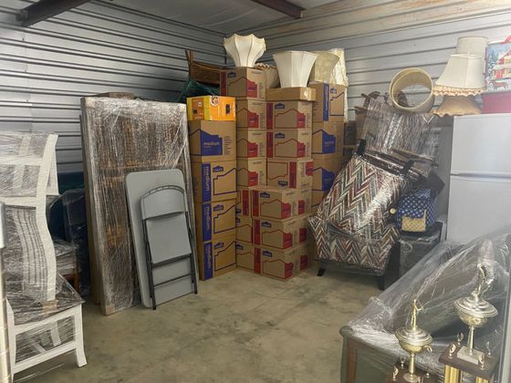 A room filled with lots of boxes and furniture.