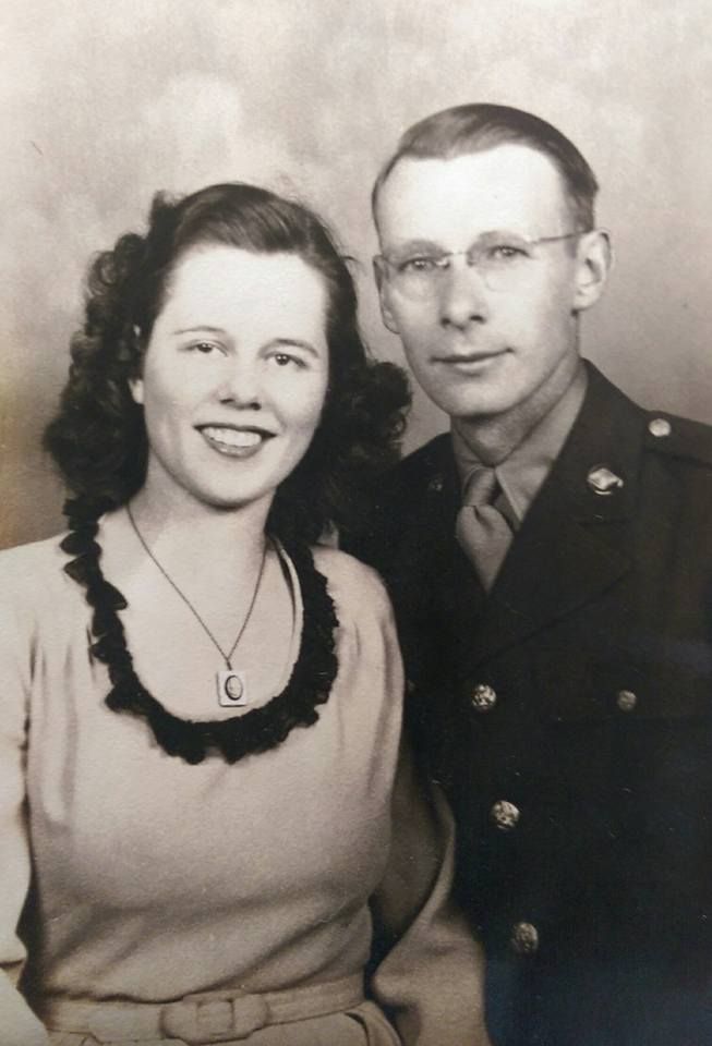 A black and white photo of a man and woman posing for a picture