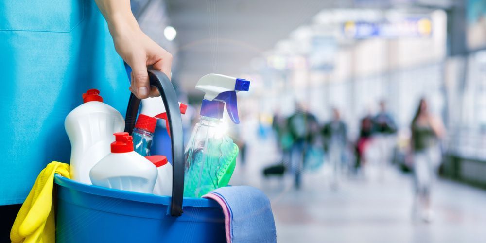 Person Holding Full Blue Bucket of Cleaning Supplies — Cleaning & Security in Charters Towers QLD